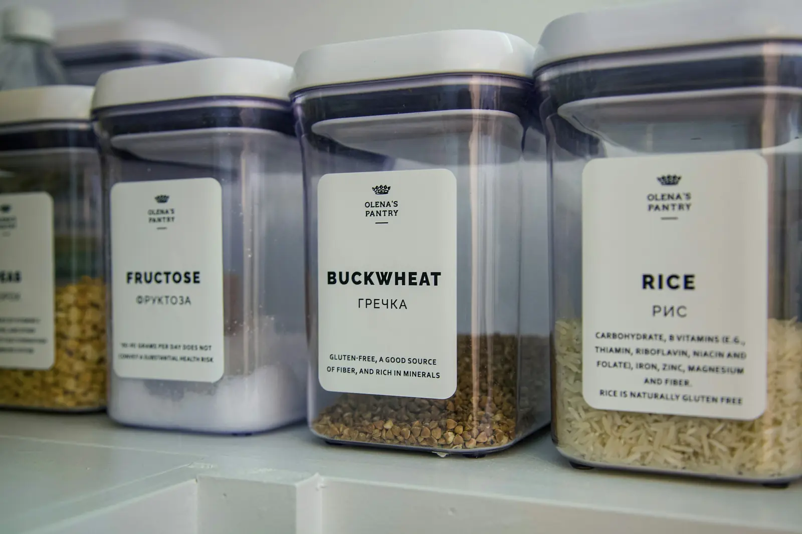 Labeled clear containers of rice and grains