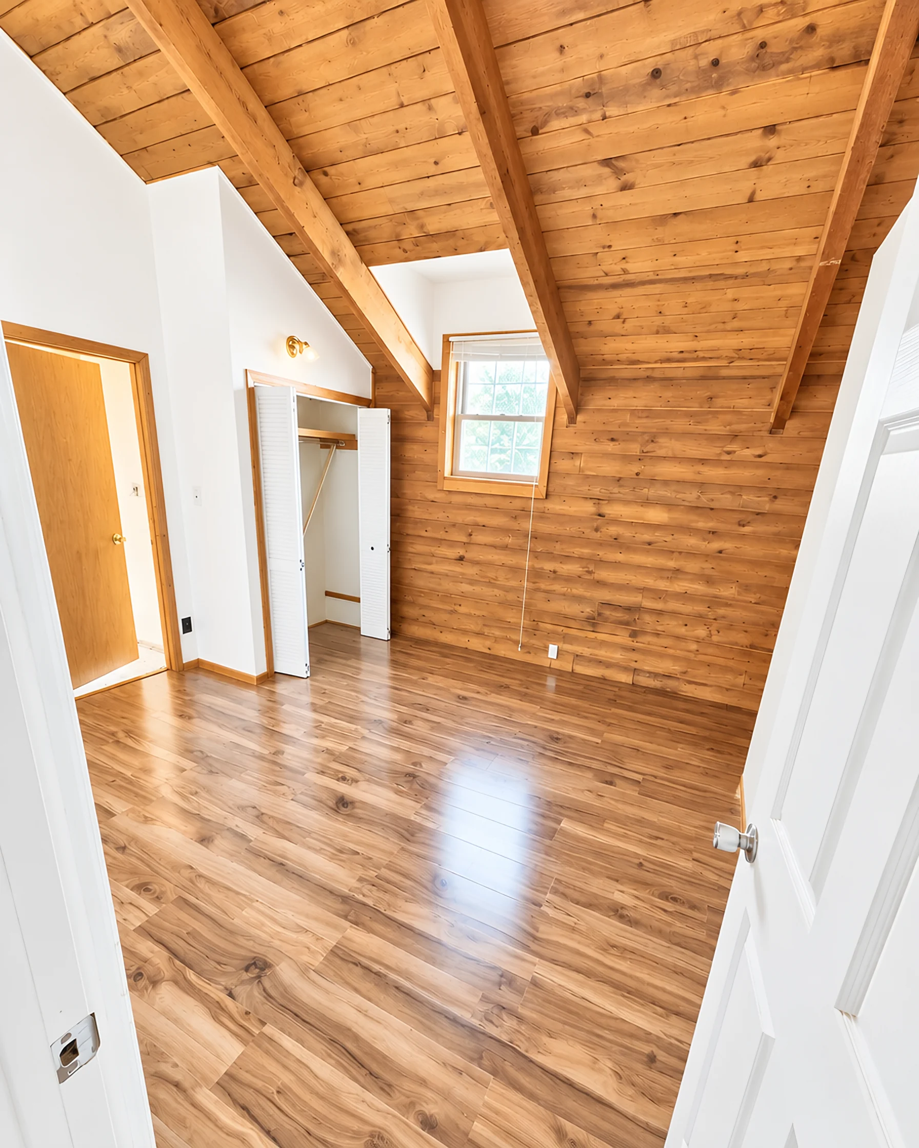 A newly installed laminate floor, cleaned and catching window light