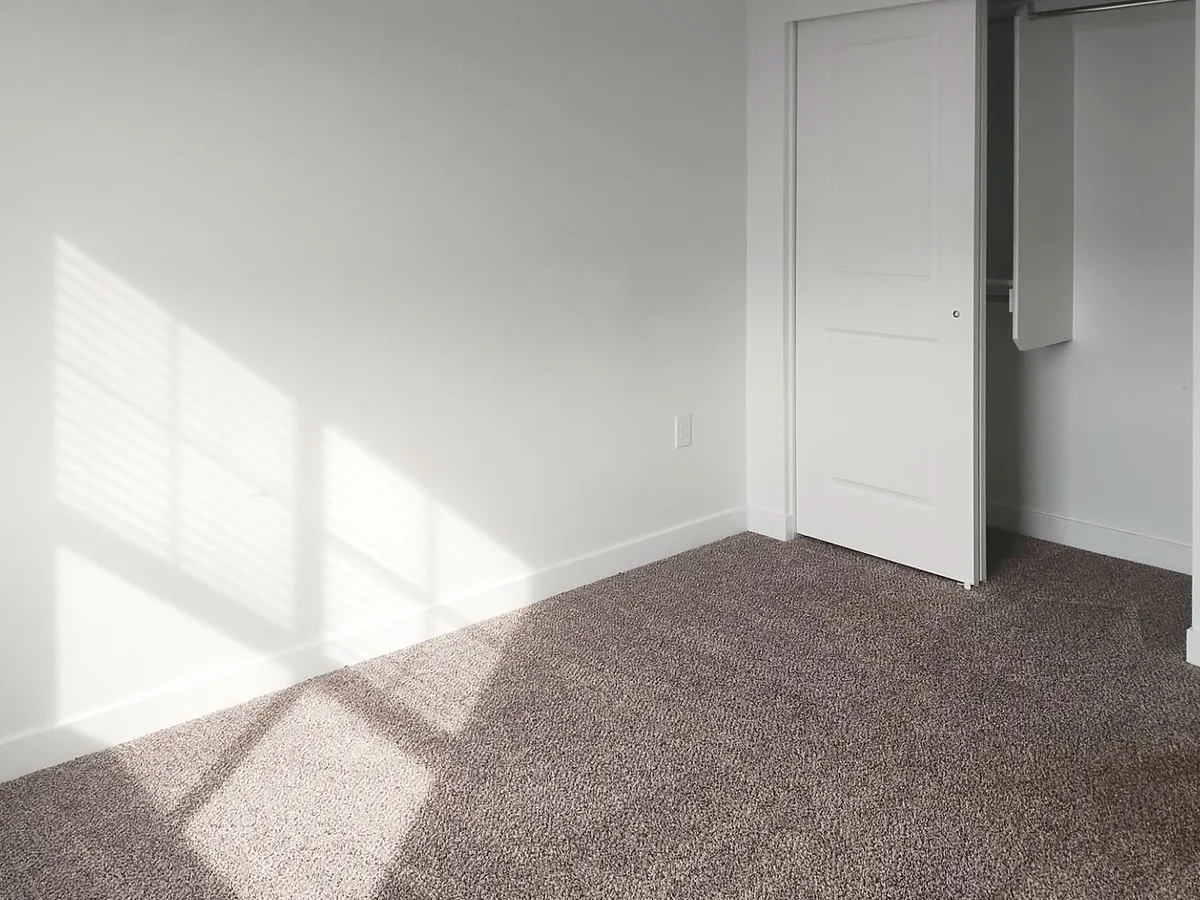 Sunlit bedroom after a move-out clean, photographed by the Wasatch Cleaners crew
