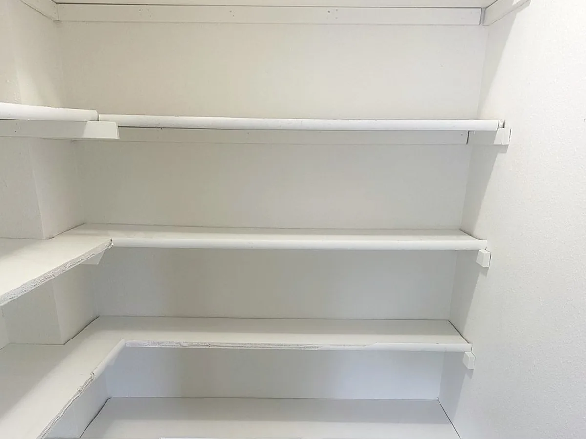Pantry shelving after a move-out clean, photographed by the Wasatch Cleaners crew